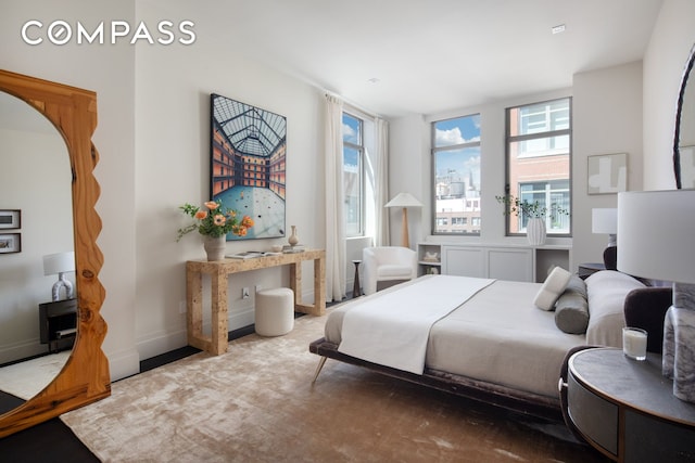 bedroom with wood finished floors and baseboards