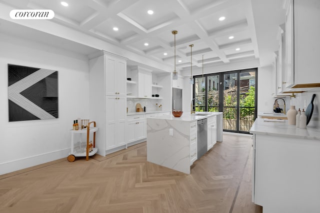 kitchen featuring decorative light fixtures, a kitchen island, light parquet flooring, light stone countertops, and white cabinets