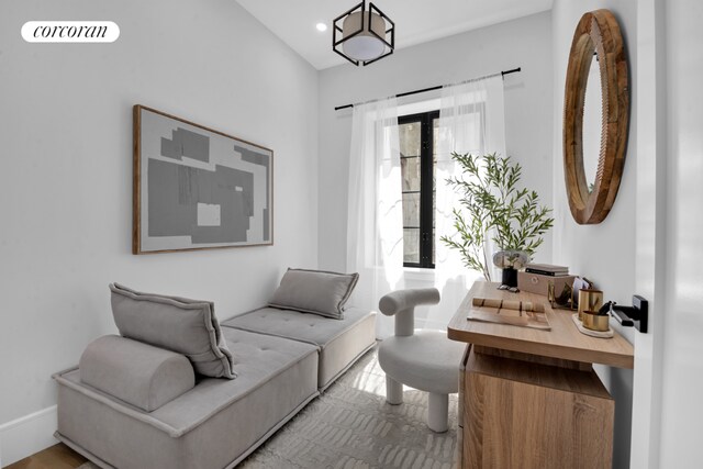 living room with an inviting chandelier and light parquet flooring