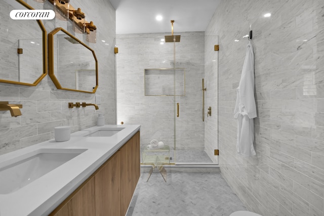 bathroom featuring vanity, a shower with shower door, and tile walls