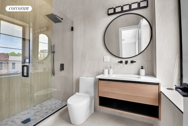 bathroom featuring tile patterned flooring, tile walls, vanity, a shower with shower door, and toilet