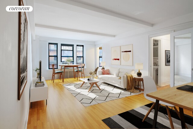 living room with beamed ceiling and light hardwood / wood-style floors