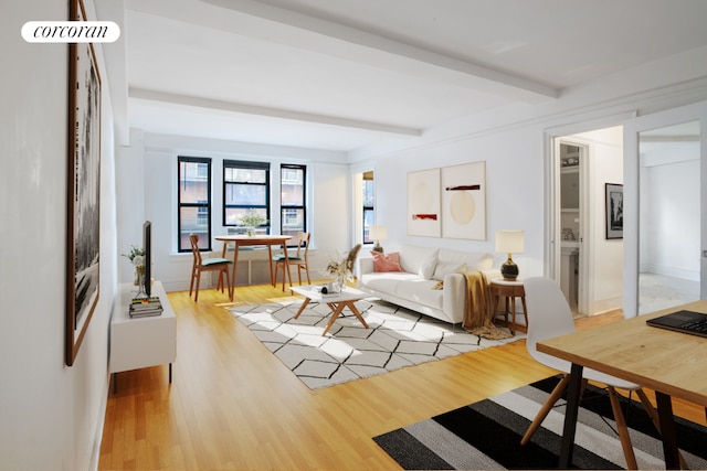 living room featuring beam ceiling and light wood-type flooring