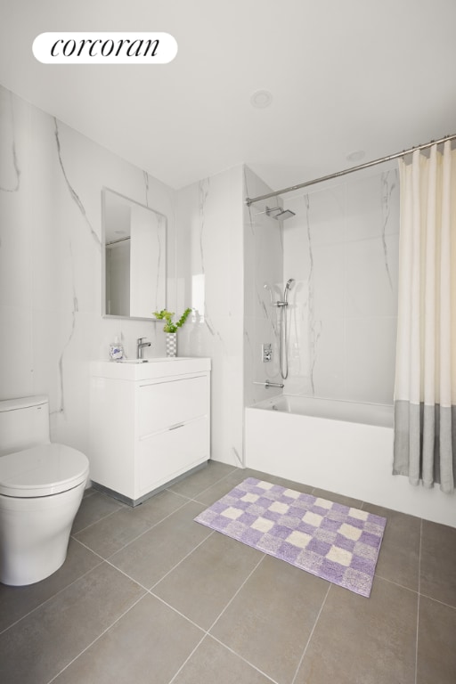 full bathroom with shower / tub combo with curtain, vanity, tile patterned floors, and toilet