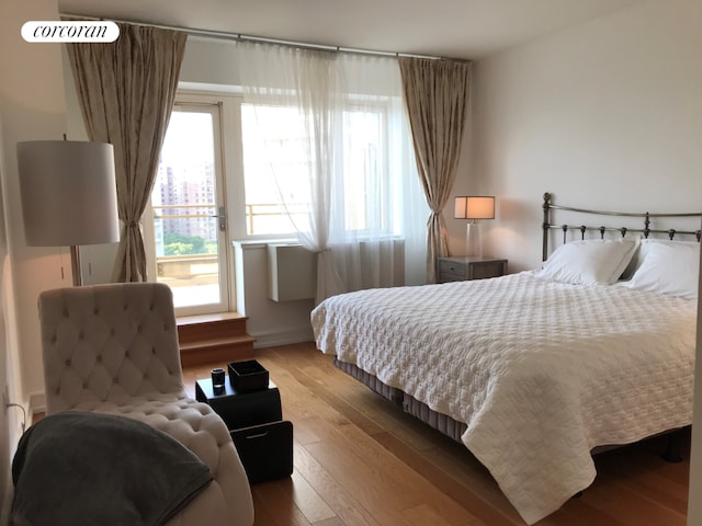 bedroom with light wood-type flooring and multiple windows