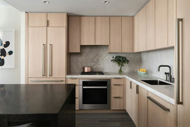 kitchen featuring tasteful backsplash, sink, light brown cabinets, stainless steel appliances, and dark hardwood / wood-style flooring