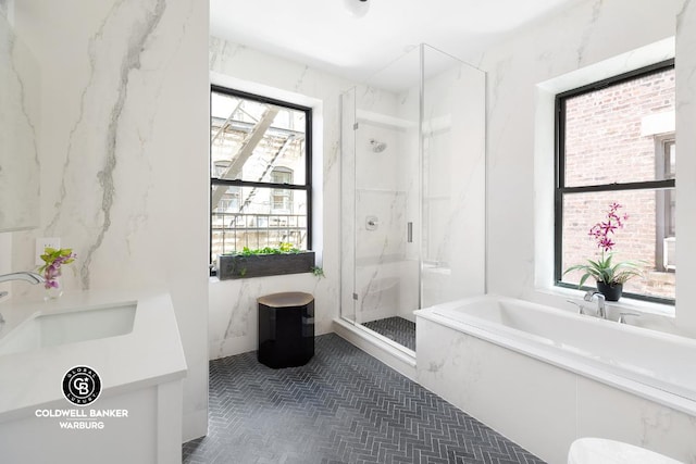 bathroom featuring vanity, independent shower and bath, and tile patterned flooring