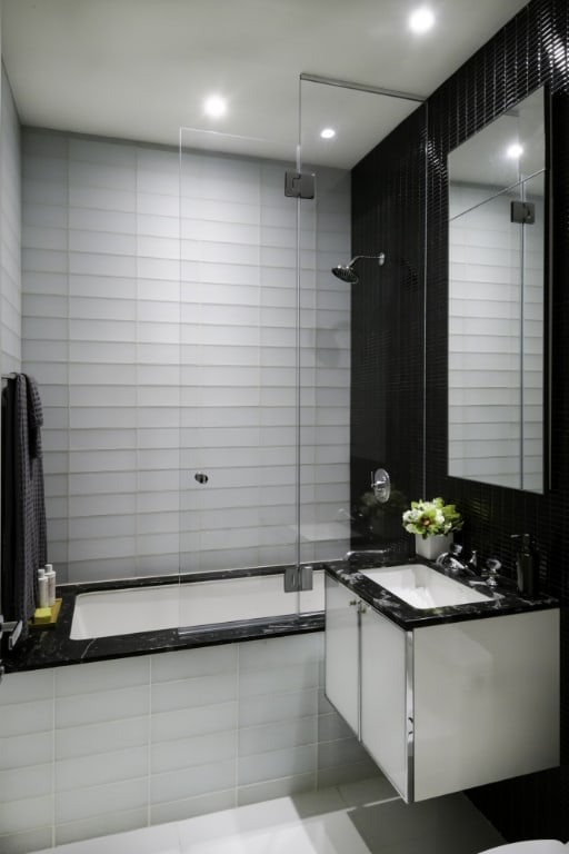 bathroom featuring vanity, tile walls, and walk in shower