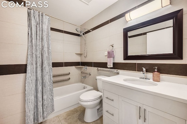 full bathroom with toilet, shower / bath combination with curtain, tile patterned floors, tile walls, and vanity