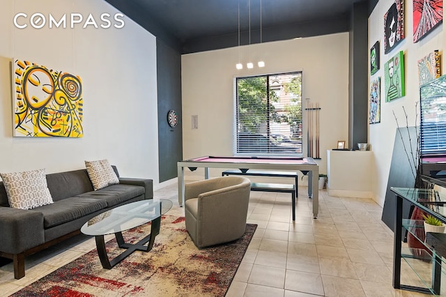 living room with tile patterned floors and baseboards