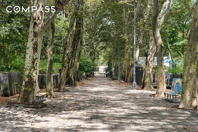 view of home's community featuring fence