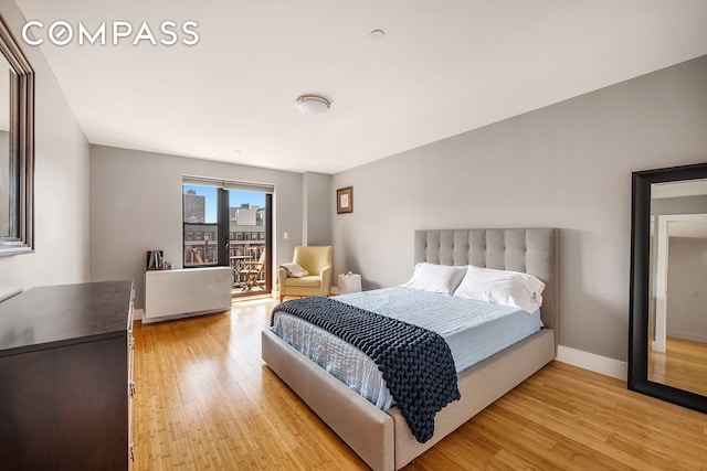 bedroom featuring light wood-type flooring, access to exterior, and baseboards