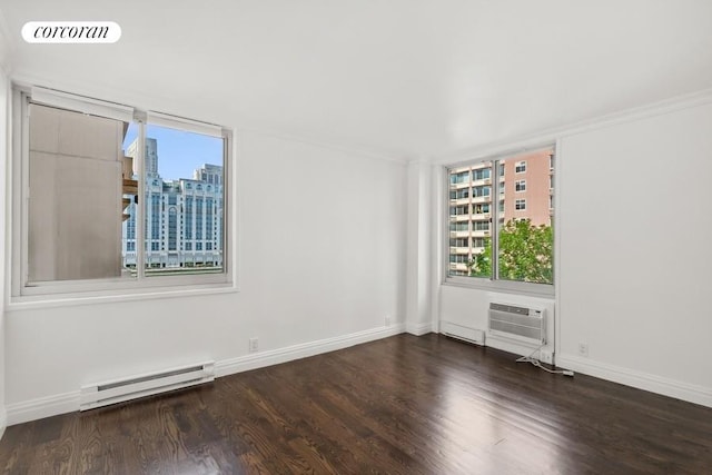 empty room with dark hardwood / wood-style flooring, a wealth of natural light, a wall mounted AC, and baseboard heating