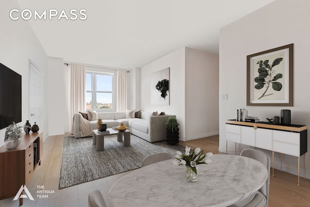 living room featuring light wood-style floors and baseboards