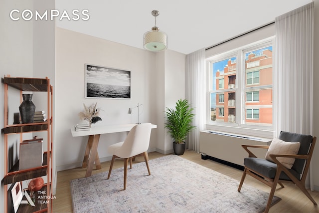 home office with a healthy amount of sunlight, light wood-style flooring, and baseboards