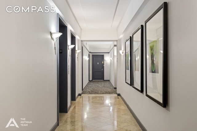 hallway featuring baseboards