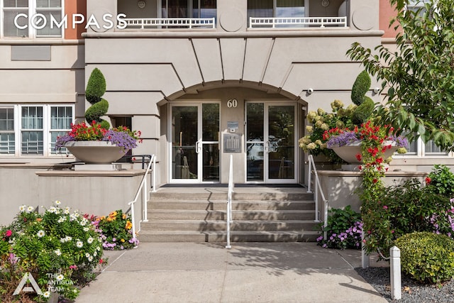 doorway to property featuring stucco siding