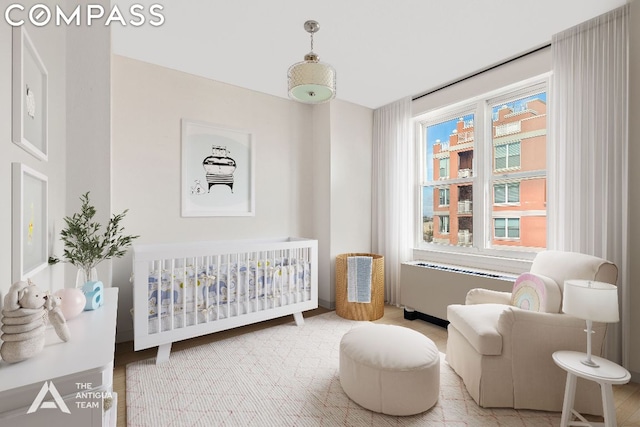 bedroom with radiator and a crib