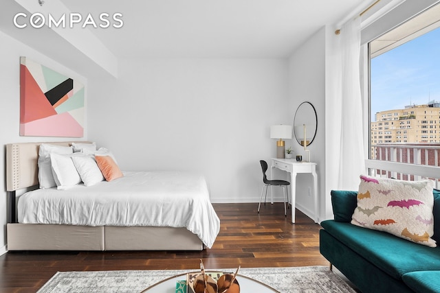 bedroom featuring wood finished floors and baseboards