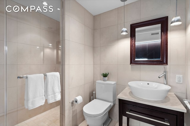 bathroom featuring tile walls, toilet, and vanity