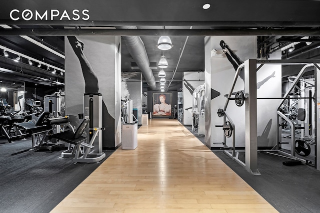 workout area with wood finished floors