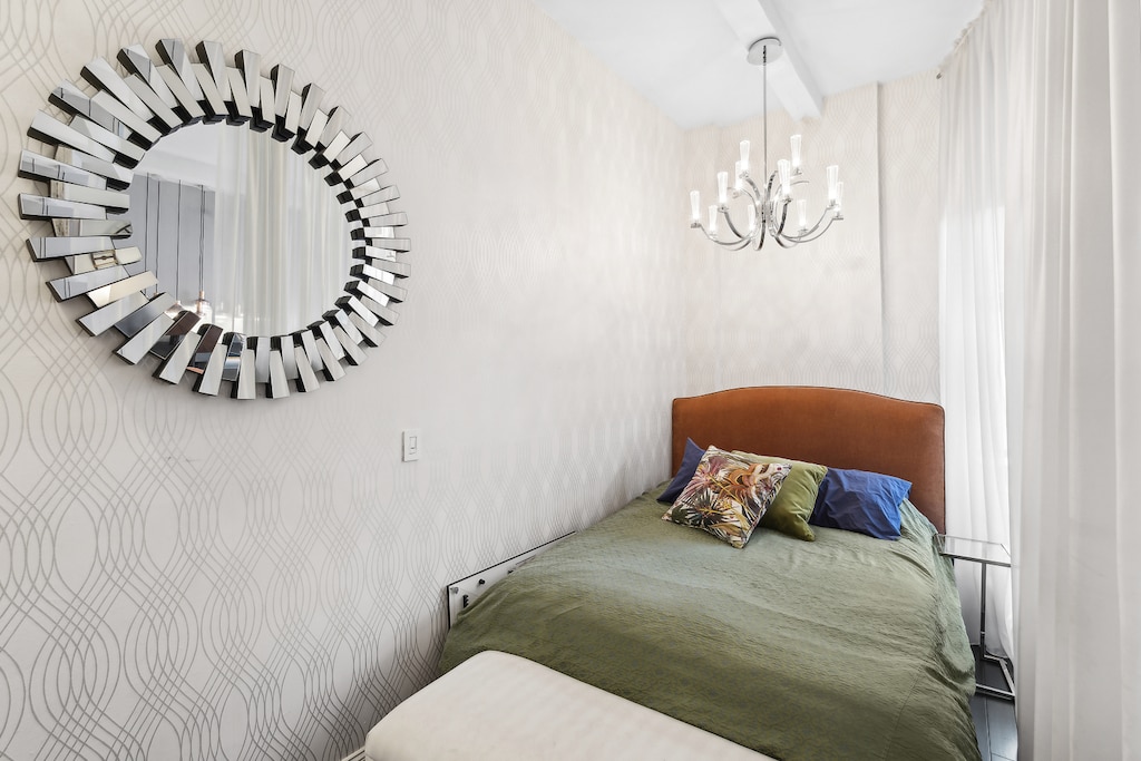 bedroom with a notable chandelier