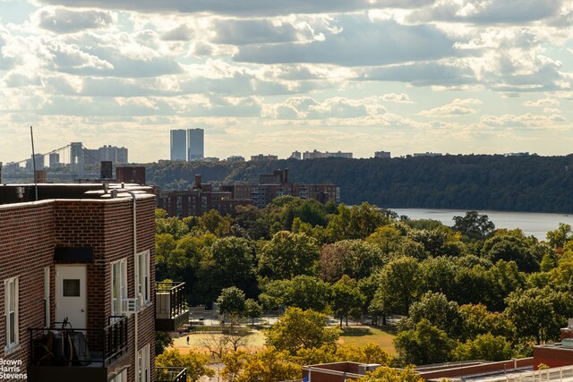 property's view of city featuring a water view and a forest view