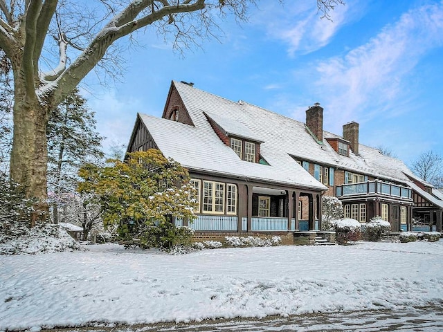 snow covered property featuring a porch