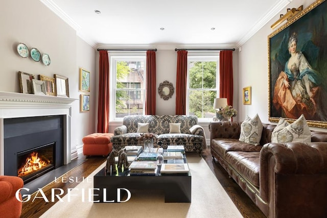 living room featuring ornamental molding, a glass covered fireplace, a healthy amount of sunlight, and dark wood finished floors