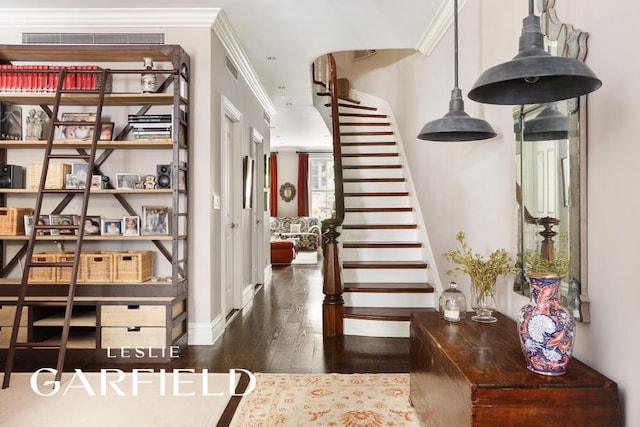 entrance foyer featuring dark wood-type flooring and ornamental molding