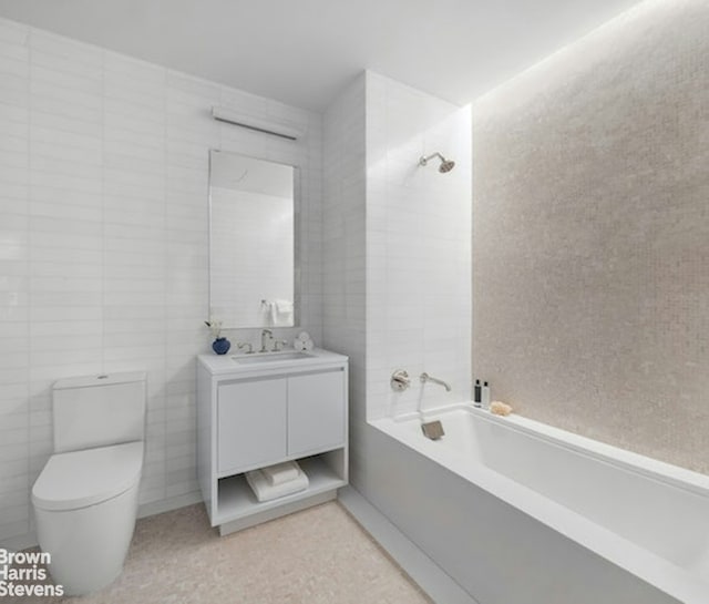 bathroom with toilet, a bathing tub, tile walls, and vanity