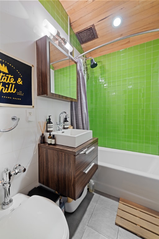 full bathroom featuring shower / tub combo with curtain, wood ceiling, tile walls, vanity, and tile patterned flooring