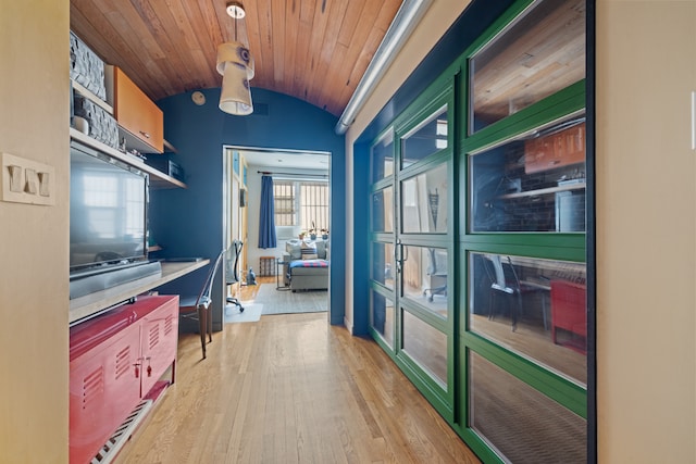 interior space featuring hanging light fixtures, vaulted ceiling, wooden ceiling, and light hardwood / wood-style floors