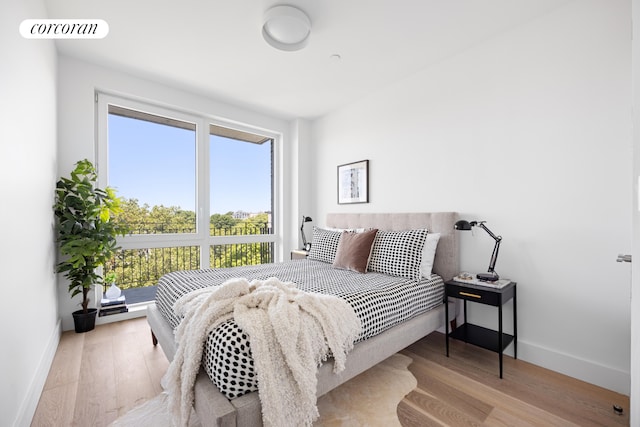 bedroom with baseboards, visible vents, and light wood-style floors