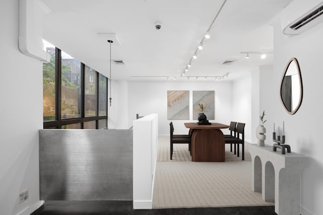 dining room featuring a wall mounted AC