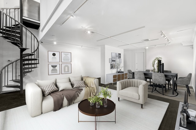 living area with visible vents, rail lighting, stairway, and wood finished floors