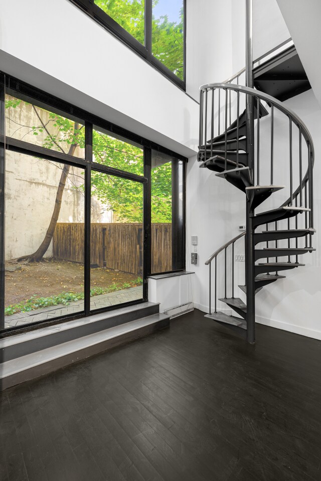 unfurnished bedroom featuring two closets, track lighting, and ornamental molding