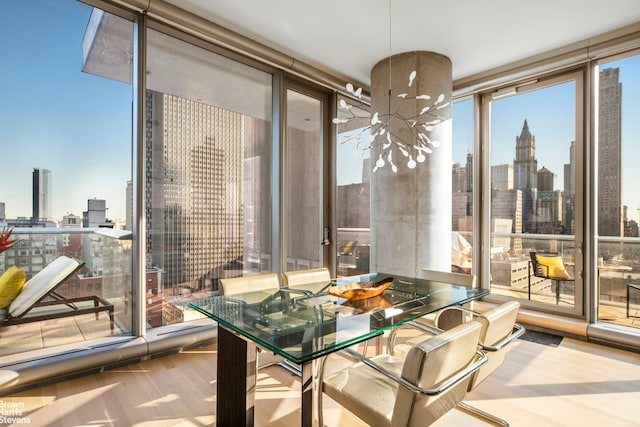 dining room featuring a wall of windows and a city view