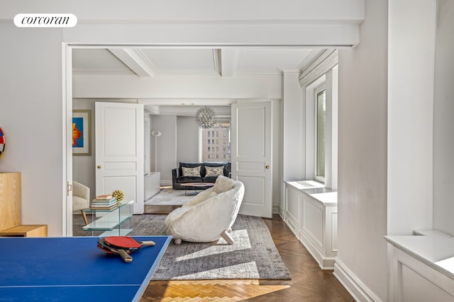 rec room featuring ornamental molding, dark parquet floors, and beam ceiling