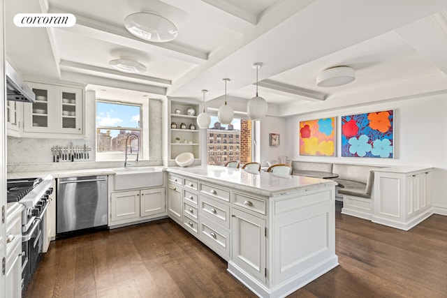 kitchen featuring pendant lighting, white cabinetry, sink, dark hardwood / wood-style flooring, and stainless steel appliances