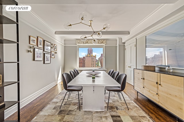 dining area with baseboards, crown molding, an inviting chandelier, and wood finished floors