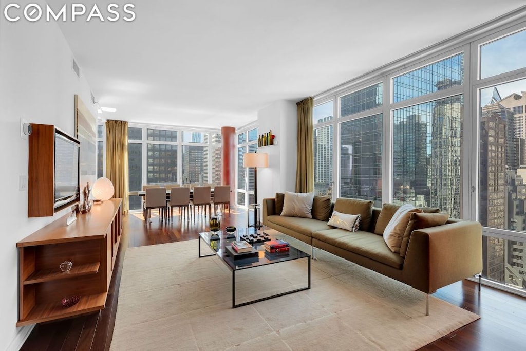 living room with floor to ceiling windows and light hardwood / wood-style floors