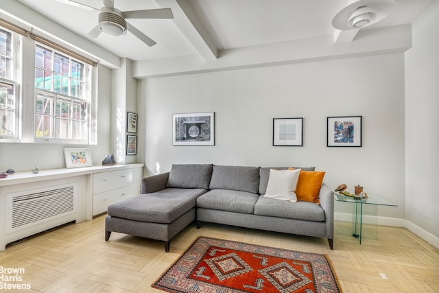 living room with ceiling fan, beamed ceiling, and light parquet floors