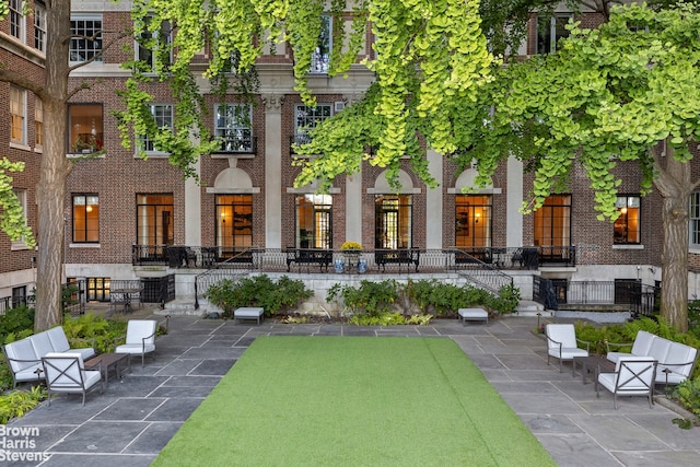 exterior space featuring a patio and brick siding