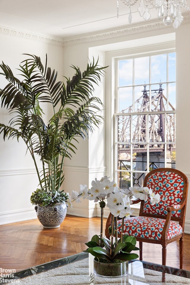 interior space featuring dark wood-type flooring, ornamental molding, and a notable chandelier