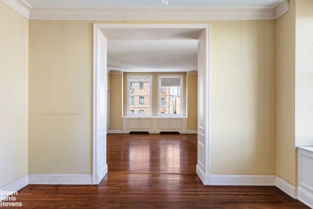 hallway featuring baseboards, dark wood-type flooring, and ornamental molding