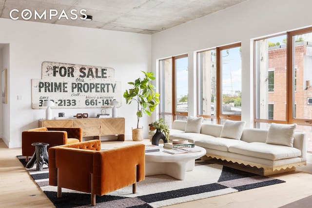 living room with plenty of natural light and wood finished floors