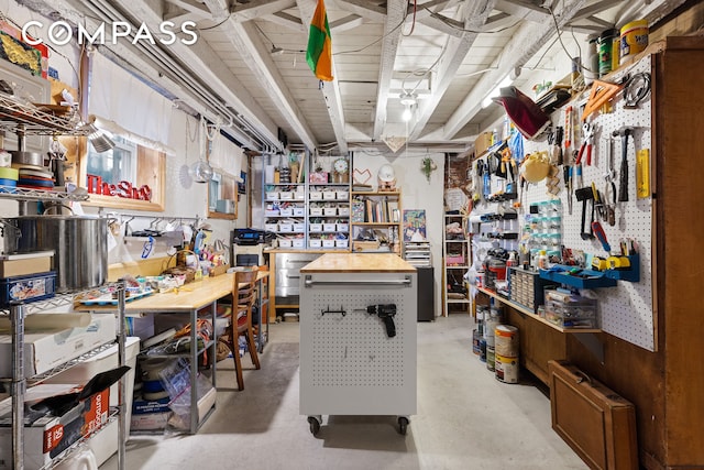 miscellaneous room with a workshop area and concrete floors