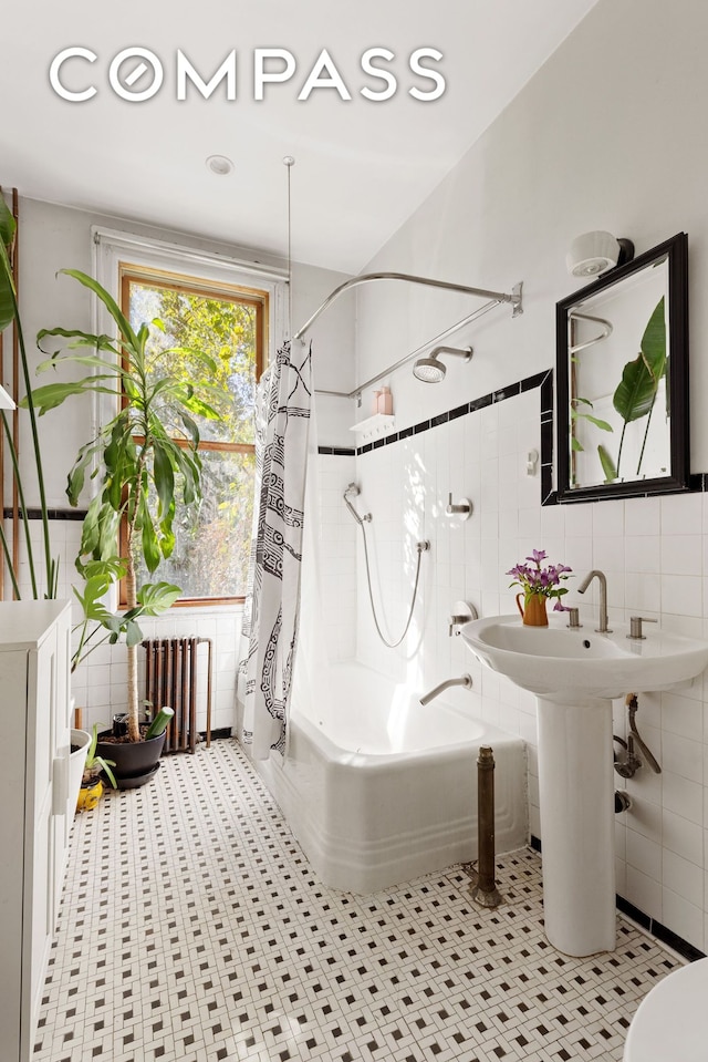 bathroom with radiator, tile walls, and shower / bathtub combination with curtain