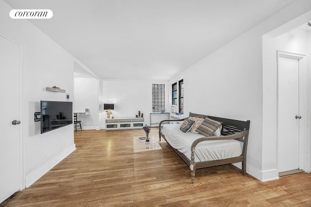 living area featuring baseboards, visible vents, and wood finished floors